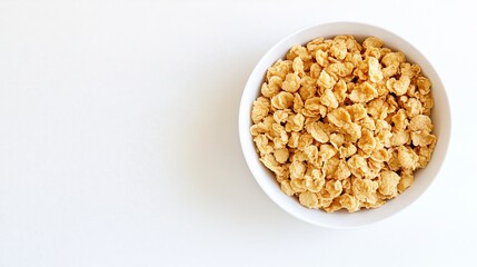 Fototapeta premium Crisp breakfast indulgence: A bowl of golden cereal delights on white background