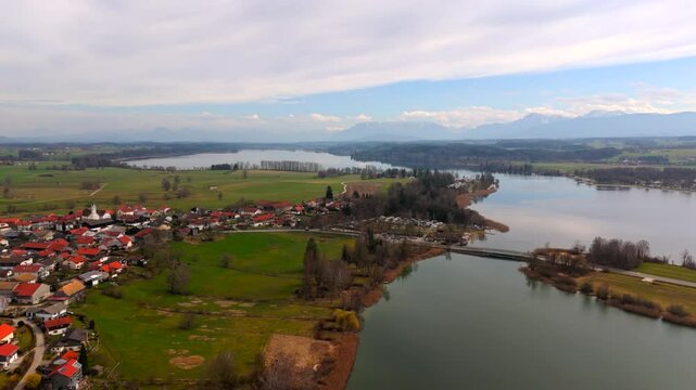 Aerial view of Waginger See in Bavaria, Germany, crystal-clear waters, rolling hills, green fields and charming villages. Waginger See Landkreis Traunstein im Rupertiwinkel Luftaufnahme im Fruehling. 