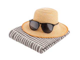 Sun hat and sunglasses resting on striped blanket for beach day on a transparent background, cut out