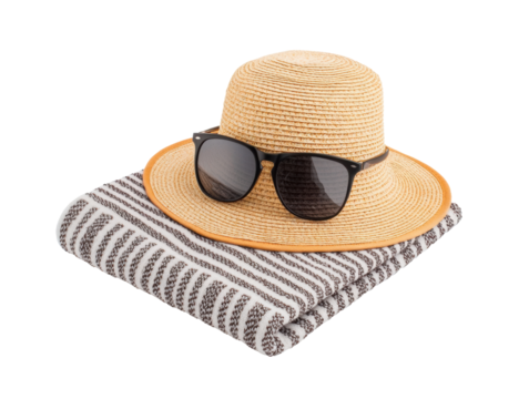 Sun hat and sunglasses resting on striped blanket for beach day on a transparent background, cut out