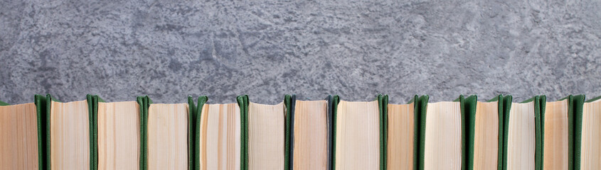 books on the gray concrete background. Back to school. Education. Copy space for text. panorama, banner.