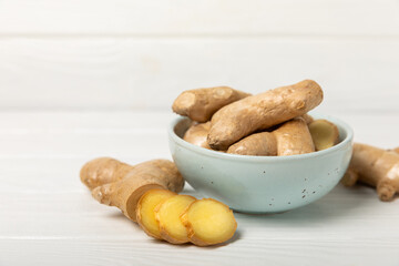 Fresh ginger on wooden background. Dry ginger. Sliced ​​ginger with honey and lemon. Ginger...