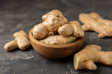 Fresh ginger on wooden background. Dry ginger. Sliced ​​ginger with honey and lemon. Ginger...