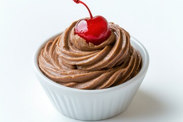A delectable dessert presented in a small white bowl consisting of rich smooth chocolate mousse topped with a glossy cherry 