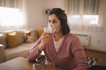 Senior woman using a nebulizer mask to manage her breathing