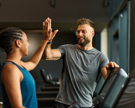 gym sport fitness exercise health training woman teamwork happy together friend success high five trainer instructor gesture support coach motivation treadmill running man trainer instructor coach