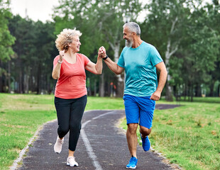 fitness woman man active sport exercise together jogging healthy fit running teamwork middle aged...