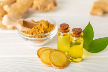 Ginger essential oil on texture background. Fresh ginger slices. Essence, serum, oil. Alternative medicine. Phytotherapy. Health and beauty concept. Place for text. Copy space.