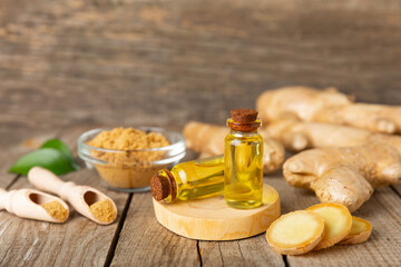 Ginger essential oil on texture background. Fresh ginger slices. Essence, serum, oil. Alternative...
