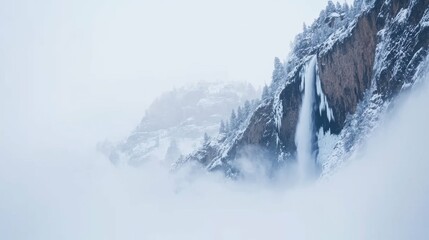 Majestic waterfall in misty valley with towering cliffs