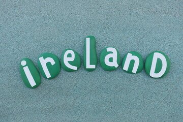 Ireland, country text composed with green hand painted stone letters over green sand