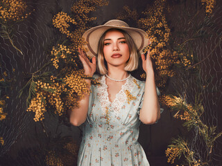 Creative Studio Portrait of a Woman Wearing a Hat Surrounded by Vibrant Yellow Flowers in a Fine Art Setting