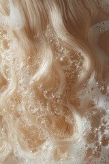 Obraz premium Close-up of blonde hair being washed with shampoo in a bathtub, with bubbles and foam on top of the long, straight hair against a green background