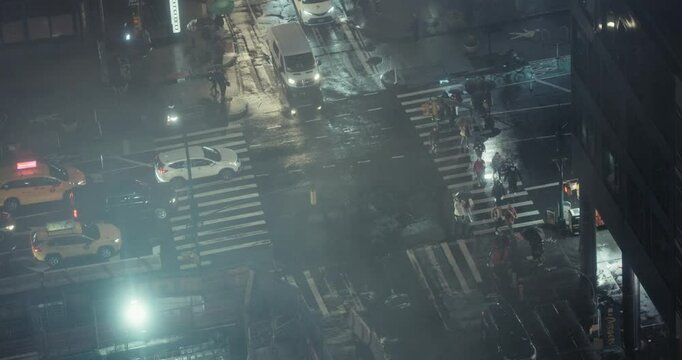 New York City streets, buildings, and traffic during a rainy winter night