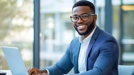 Fototapeta premium Portrait of a Confident Professional: A vibrant portrait captures a smiling, stylish businessman working diligently on his laptop