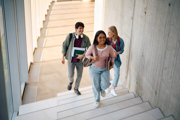 Fototapeta premium Multiracial group of happy students going on lecture at university.