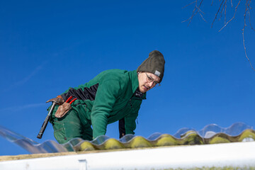 Portrait of Roofer Working on Carport Roof Repair.