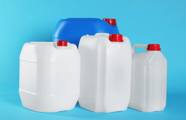 Different plastic canisters on light blue background