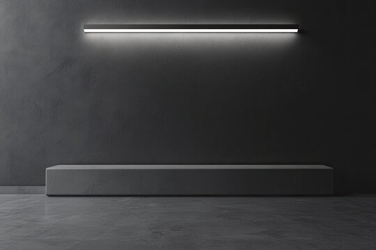 Modern, minimalist, dark gray room with a simple light fixture and a low platform