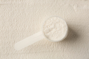 Collagen powder and scoop as background, top view