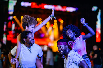 Friends enjoying a vibrant music festival night