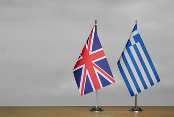 Table flags United Kingdom and Greece on grey blurred background