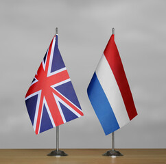 Table flags United Kingdom and Netherlands on grey blurred background