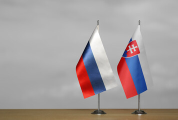 Table flags Russia and Slovakia on grey blurred background
