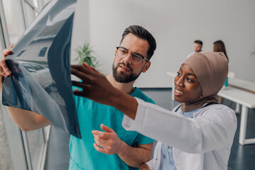 Doctors examining x ray of patient in hospital