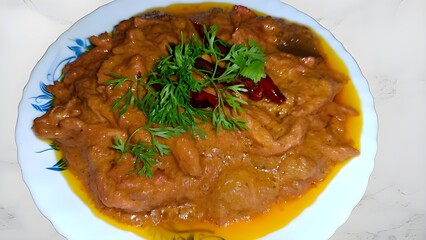 A rich and flavorful creamy chicken curry, cooked with aromatic spices, garnished with fresh coriander and dried red chilies. Perfect for pairing with rice or naan.