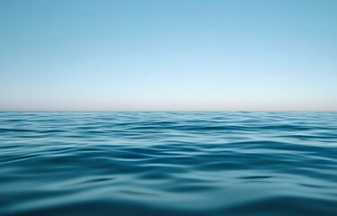 Obraz premium Calm blue ocean stretching to the horizon under a clear sky, capturing the vastness and tranquility of the sea in a serene, minimalist composition