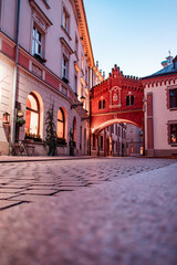 A street in the old town. An empty, cozy, and clean street lined with cafes and restaurants beautifully decorated with flowers and lighting.