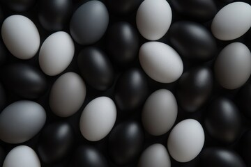 A collection of matte black, grey and white easter eggs lays scattered against a solid black background, Generative AI