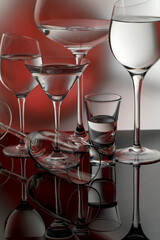 Glass goblets on a black glass table