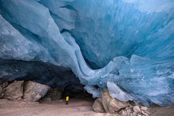 Dangerous ice cave entrance with huge hanging ice block overhead in the Swiss Alps Moteratsch Glacier.  (March 2025)