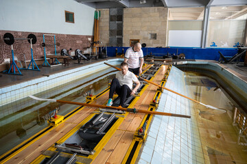 Swimmer athletes arrange in designated order for rowing simulator practice in pool. Sports preparation for championship, teamwork discipline and strategic alignment for aquatic sports training