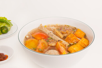 Bun Rieu Cua, Crab paste vermicelli soup with minced shrimp, tofu, tomato, shrimp paste, Vietnamese food isolated on white background, close up