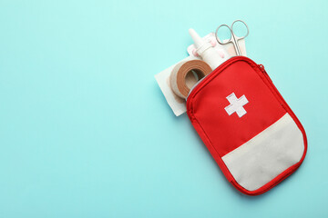 First aid kit. Different medical supplies on light blue background, top view. Space for text