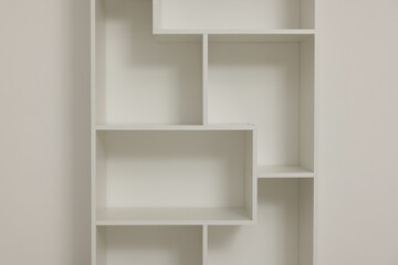 Empty shelving unit near light wall indoors, closeup