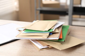 Many different envelopes on table in post office
