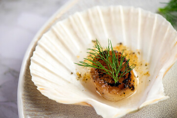 Grilled scallops with butter, quinoa pop, garlic, lime