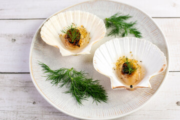 Grilled scallops with butter, quinoa pop, garlic, lime