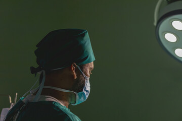 tired male caucasian doctor break operating. specialist surgical man exhausted working hard doing surgery rest in the back. male surgeon wearing uniform have break from working in emergency operation