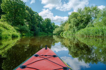 rafting on calm water. Green kayak and beautiful scenery
