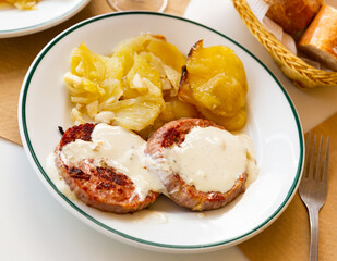 Appetizing turkey cutlets with sauce and stewed cabbage leaves