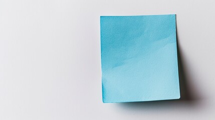 A blue sticky note is on a white background