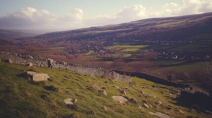 Stone wall overlooks a valley town nestled in hills