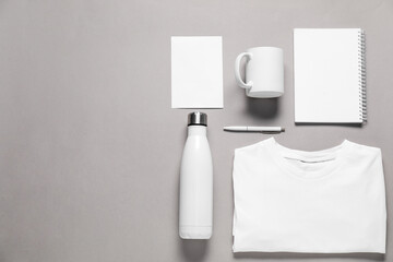 Different blank items for branding on grey background, flat lay. Mockup for design