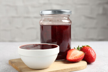 Delicious strawberry sauce and fresh berries on light table