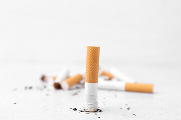 Cigarette butts on light background, selective focus